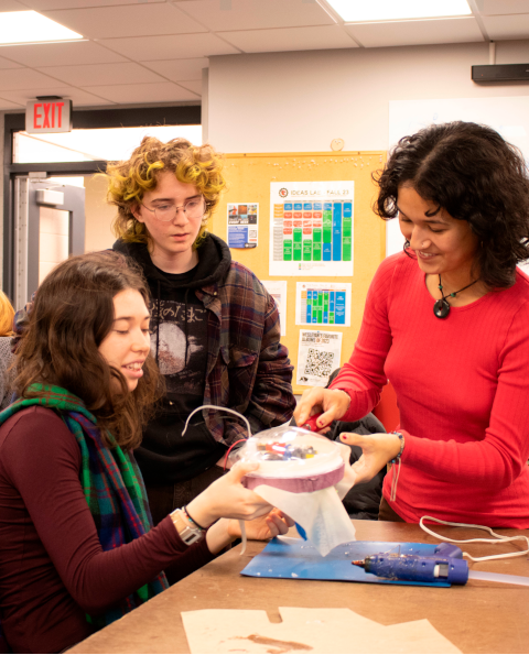HOPPERS, SWIMMERS, AND CLIMBERS: Students in IDEA 170 explore biological organisms to find design inspiration for machines that hop, swim, and climb. (Left to right) Madeline Frew ’24, Eliah Seignourel ’26, and Leza Rooks ’26 make modifications to their jellyfish prototype.
