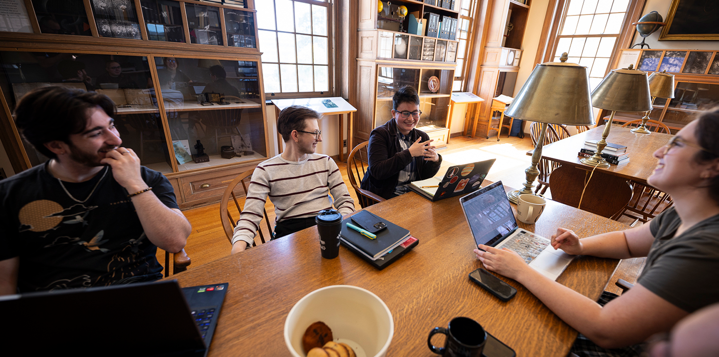 Students gather together in the Van Vleck Observatory with laptops
