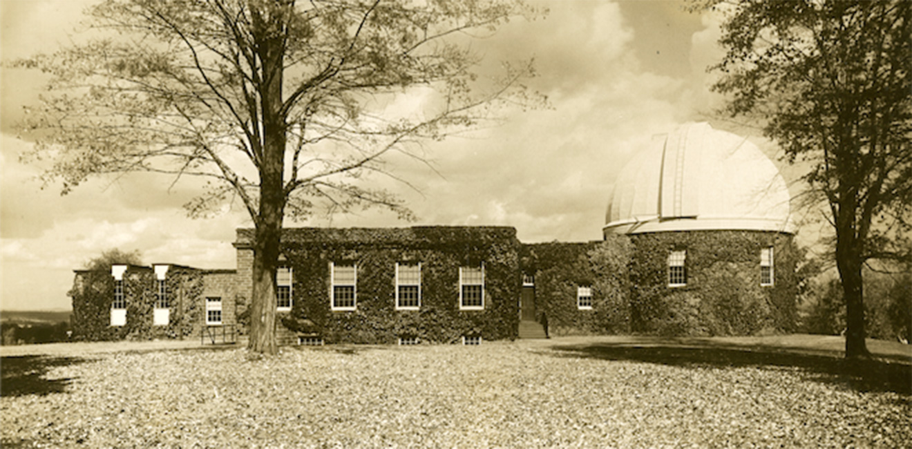 Vintage sepia-toned photo of the Van Vleck Observatory covered in ivy