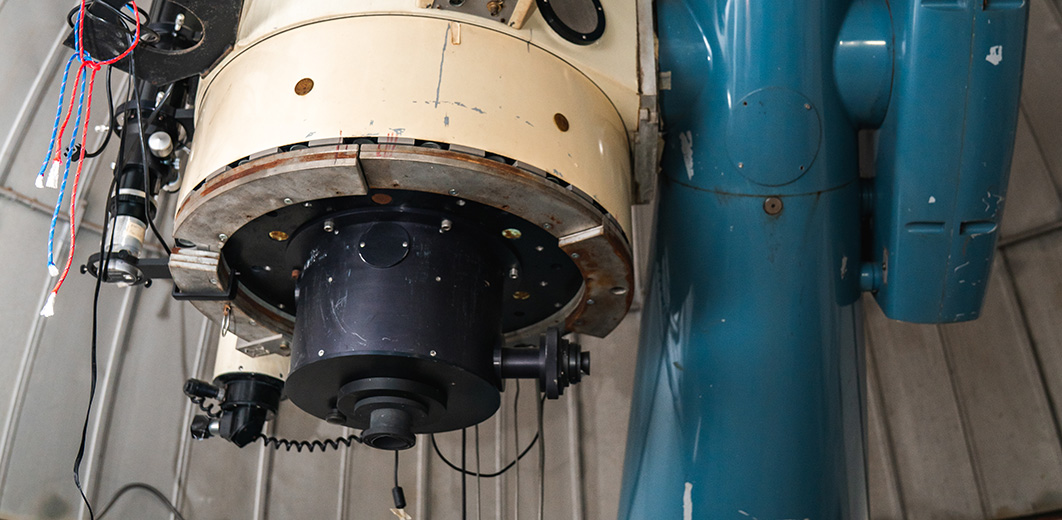 Close-up of the 24-inch Perkin Telescope with its blue mount and attached instrumentation.