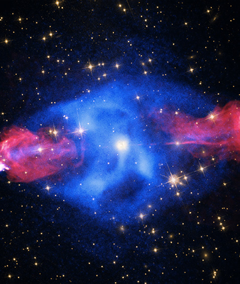 Deep space view showing a star field with a bright blue nebula and scattered stars against a dark background.