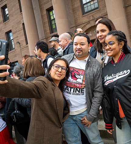 Alumni outside North College posing together
