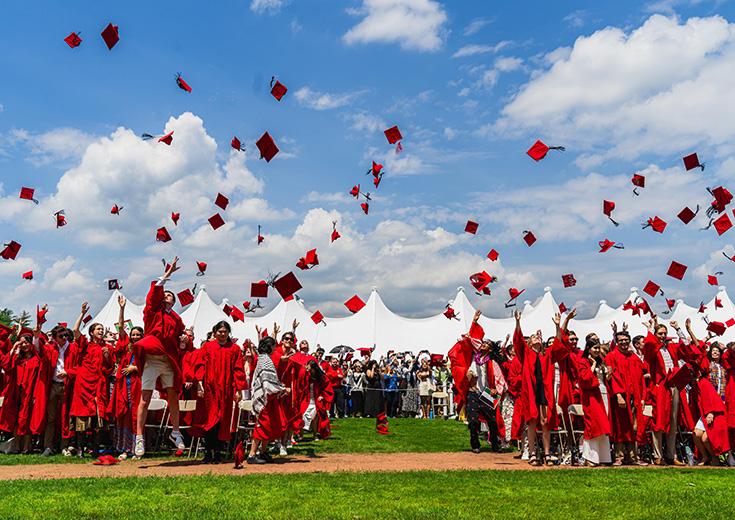 Wesleyan Graduates throw their caps at their commencement ceremony